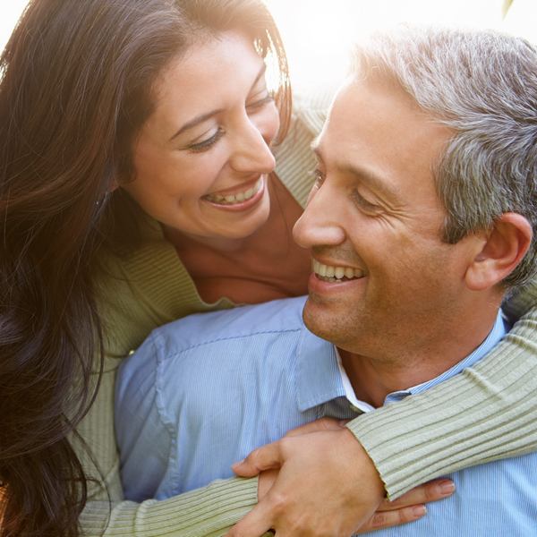 Middle-aged couple is smiling and hugging